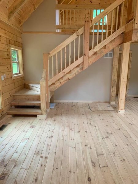 Wooden interior with staircase and natural light.