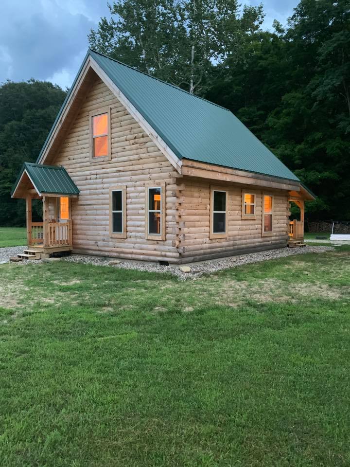 Log cabin with green roof in nature.