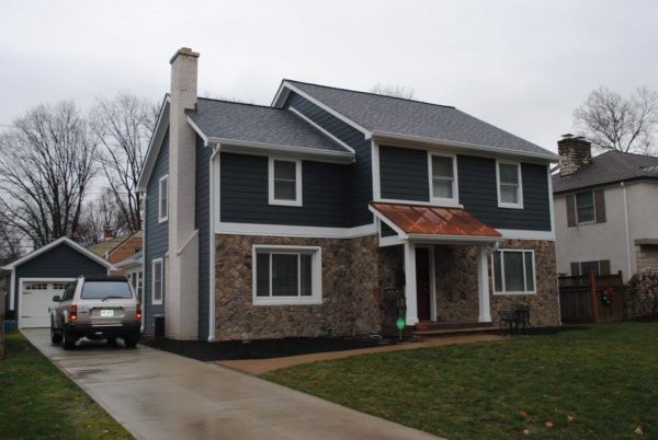 Two-story house with driveway and car.