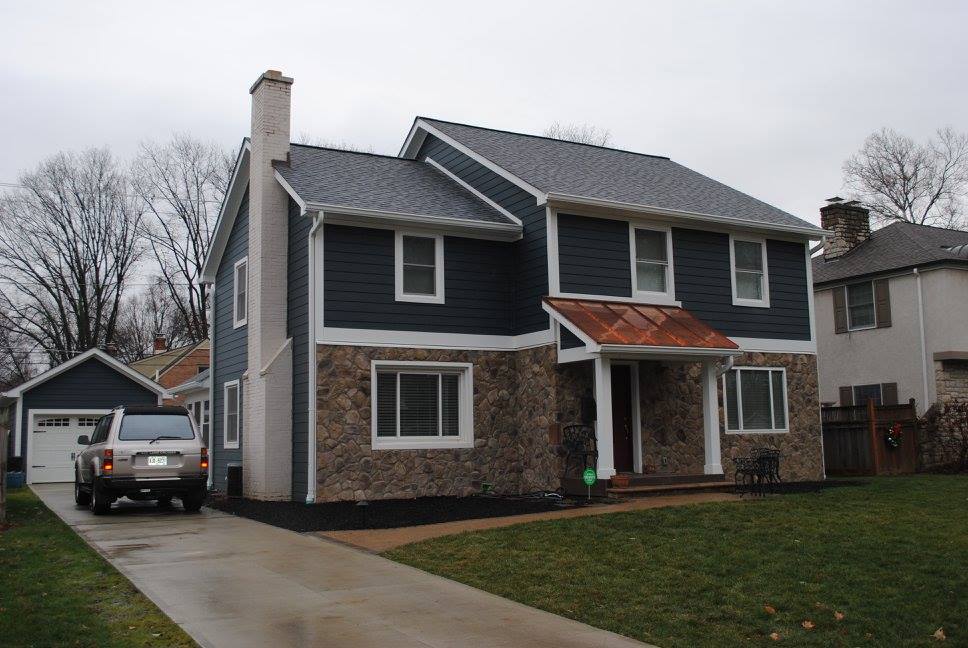 Two-story house with driveway and car.