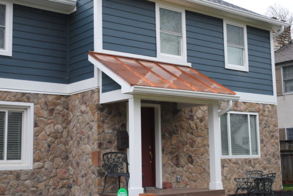House with stone facade and metal awning.