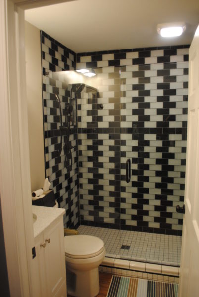 Modern bathroom with black and white tiles.