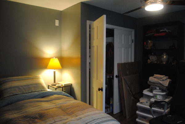 Cozy bedroom with lamp and open closet.