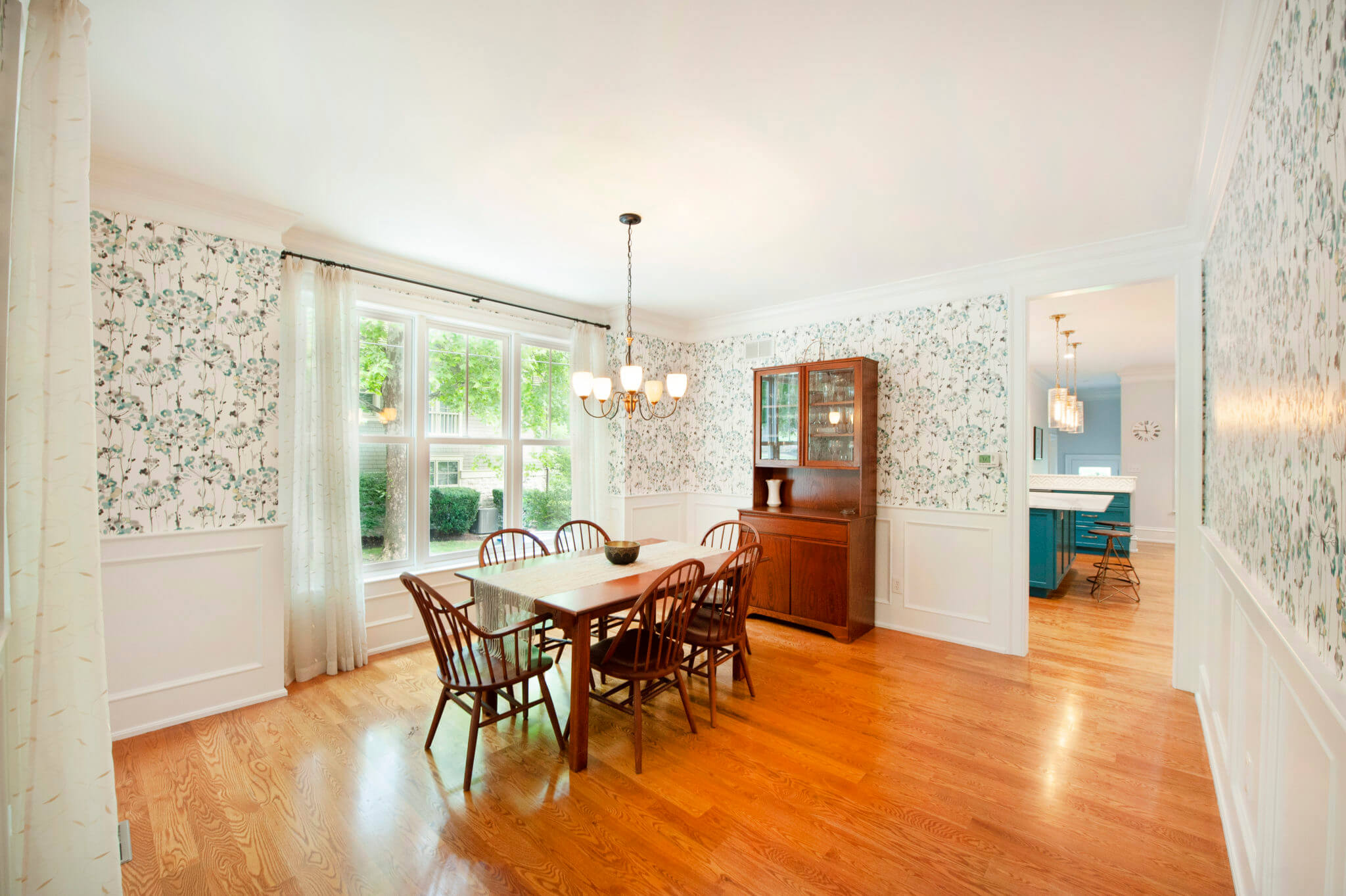 Dining room with wooden table and chairs.