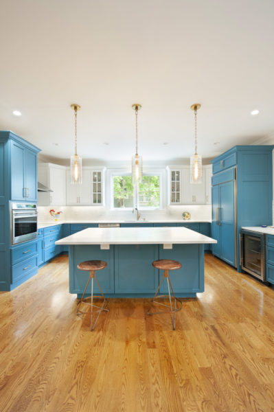 Modern kitchen with blue cabinets and island.