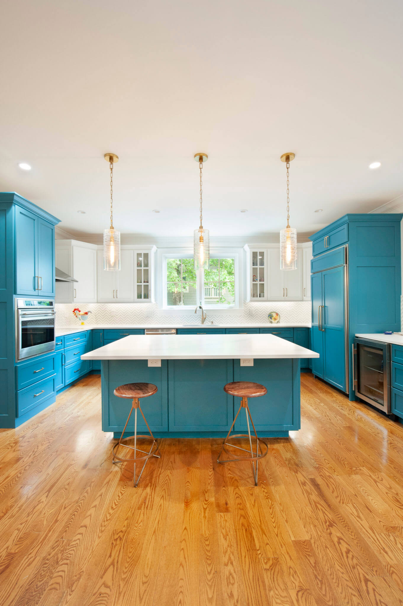Modern kitchen with blue cabinets and island.