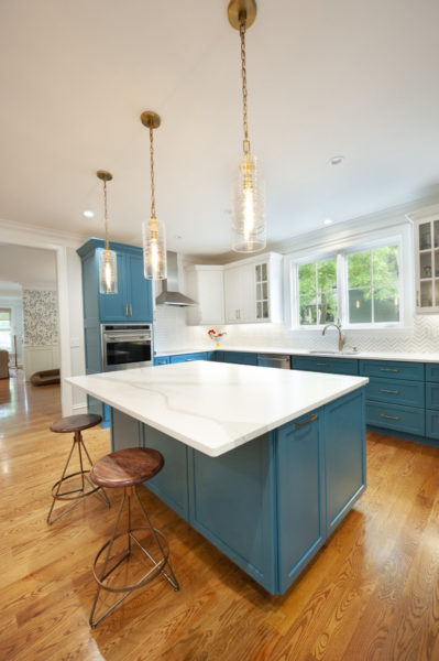 Modern kitchen with blue cabinets and island.