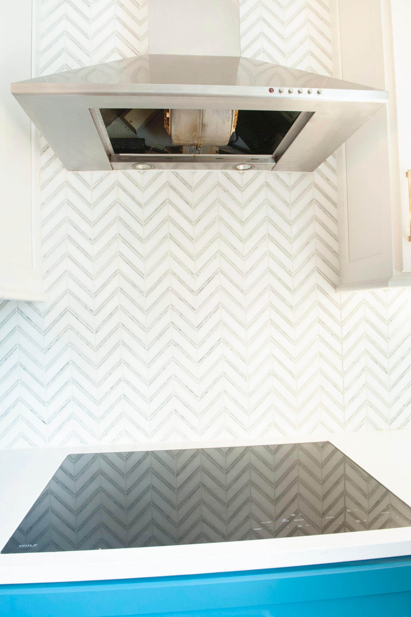 Modern kitchen with stove and range hood.