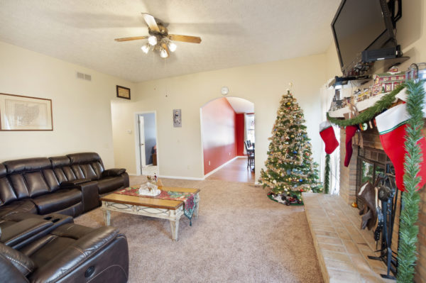 Living room with Christmas tree and stockings.