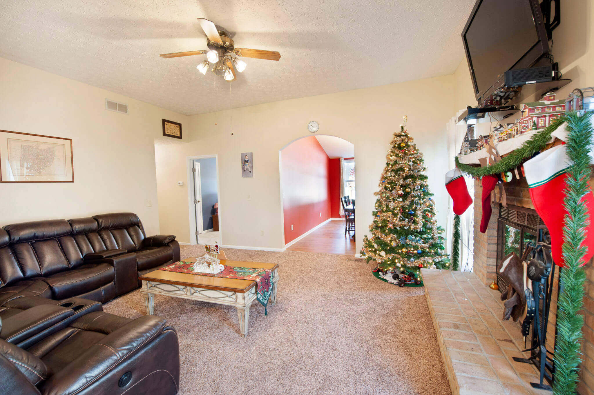 Living room with Christmas tree and stockings.