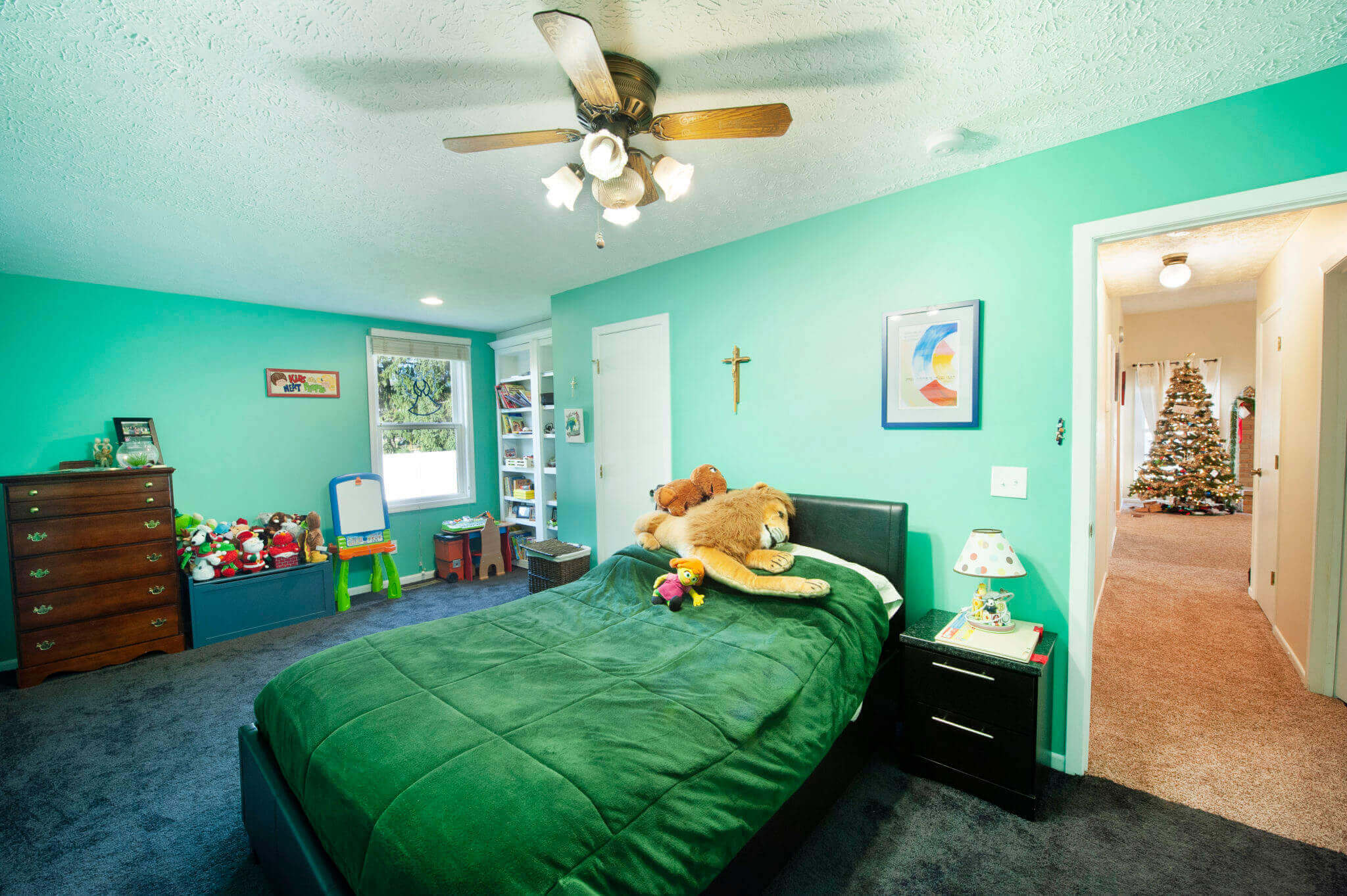 Child's bedroom with toys and Christmas tree.