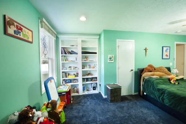 Children's room with toys and bookshelf.