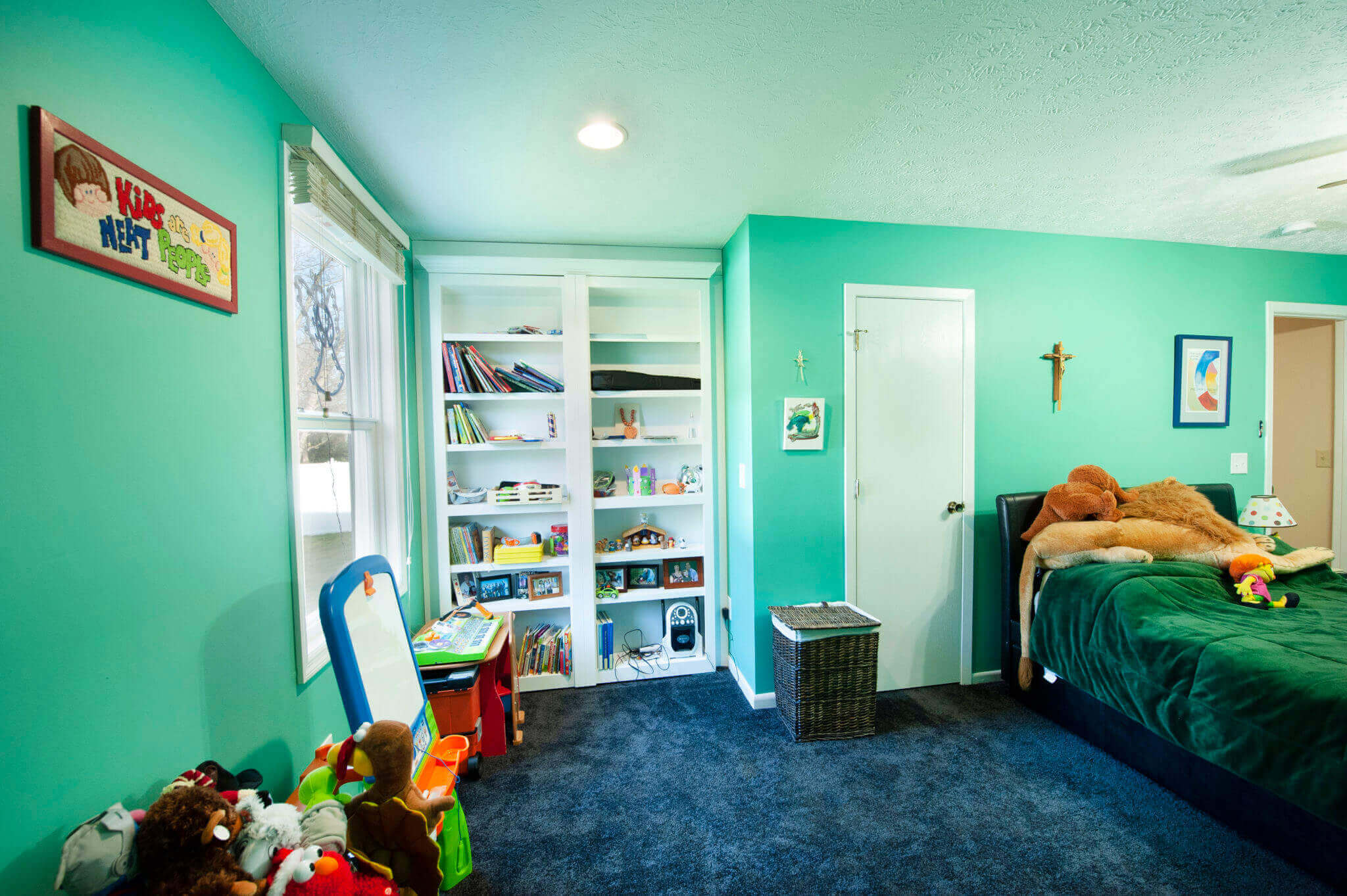 Children's room with toys and bookshelf.