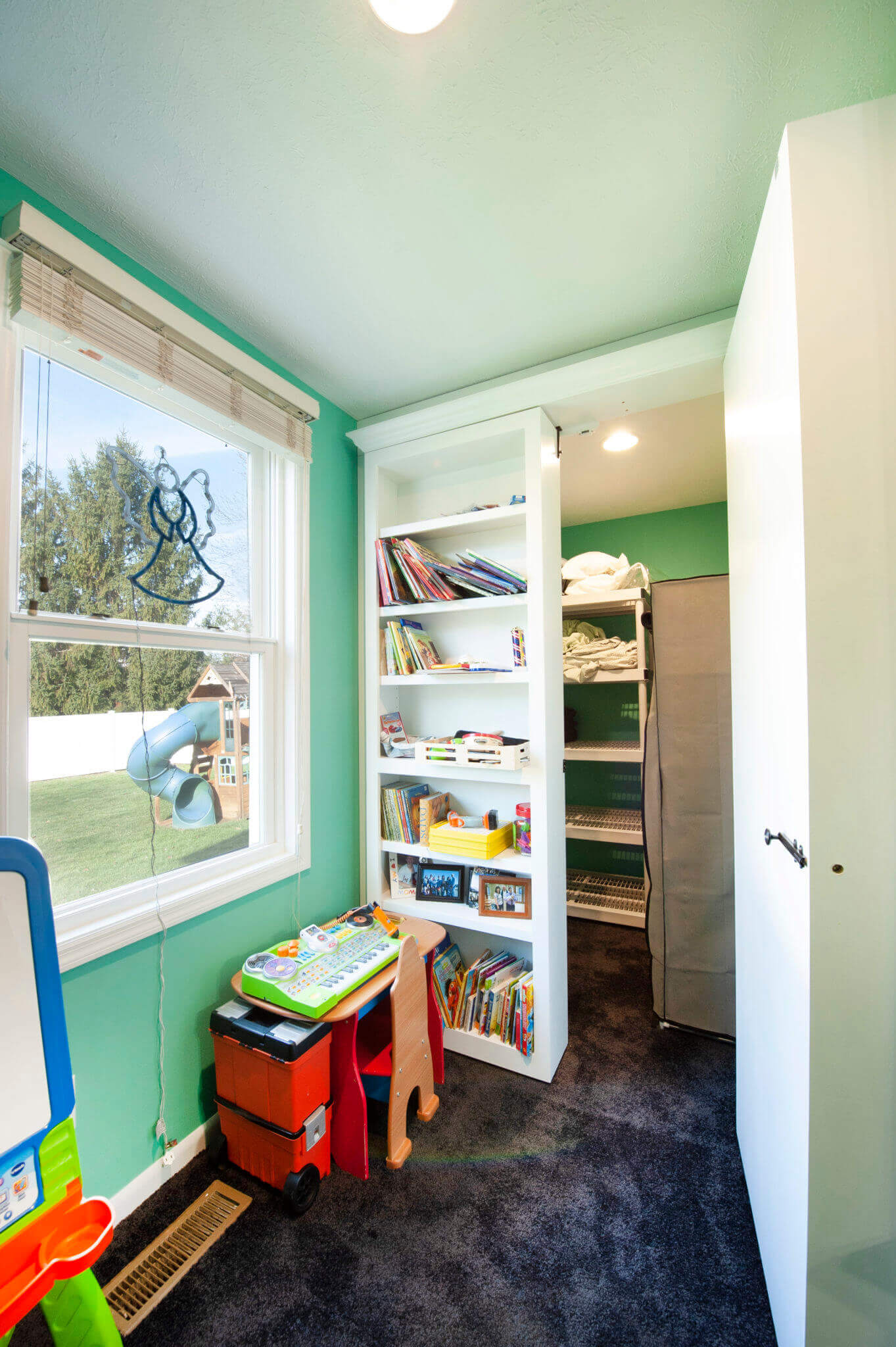 Children's playroom with books and toys.