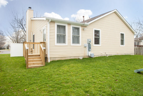 Single-story house with beige siding exterior.