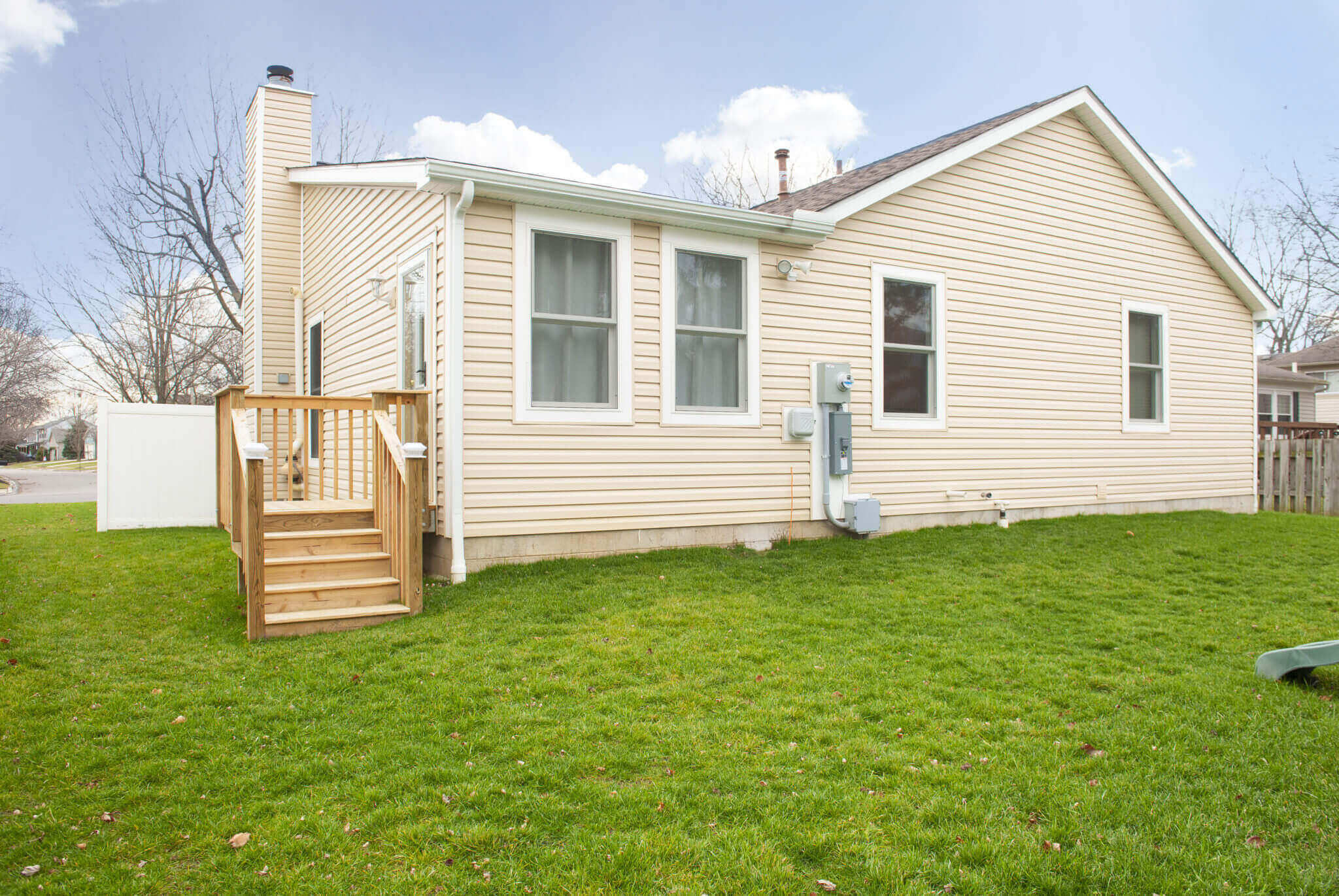 Single-story house with beige siding exterior.