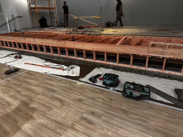 Construction site with wooden framework and tools.