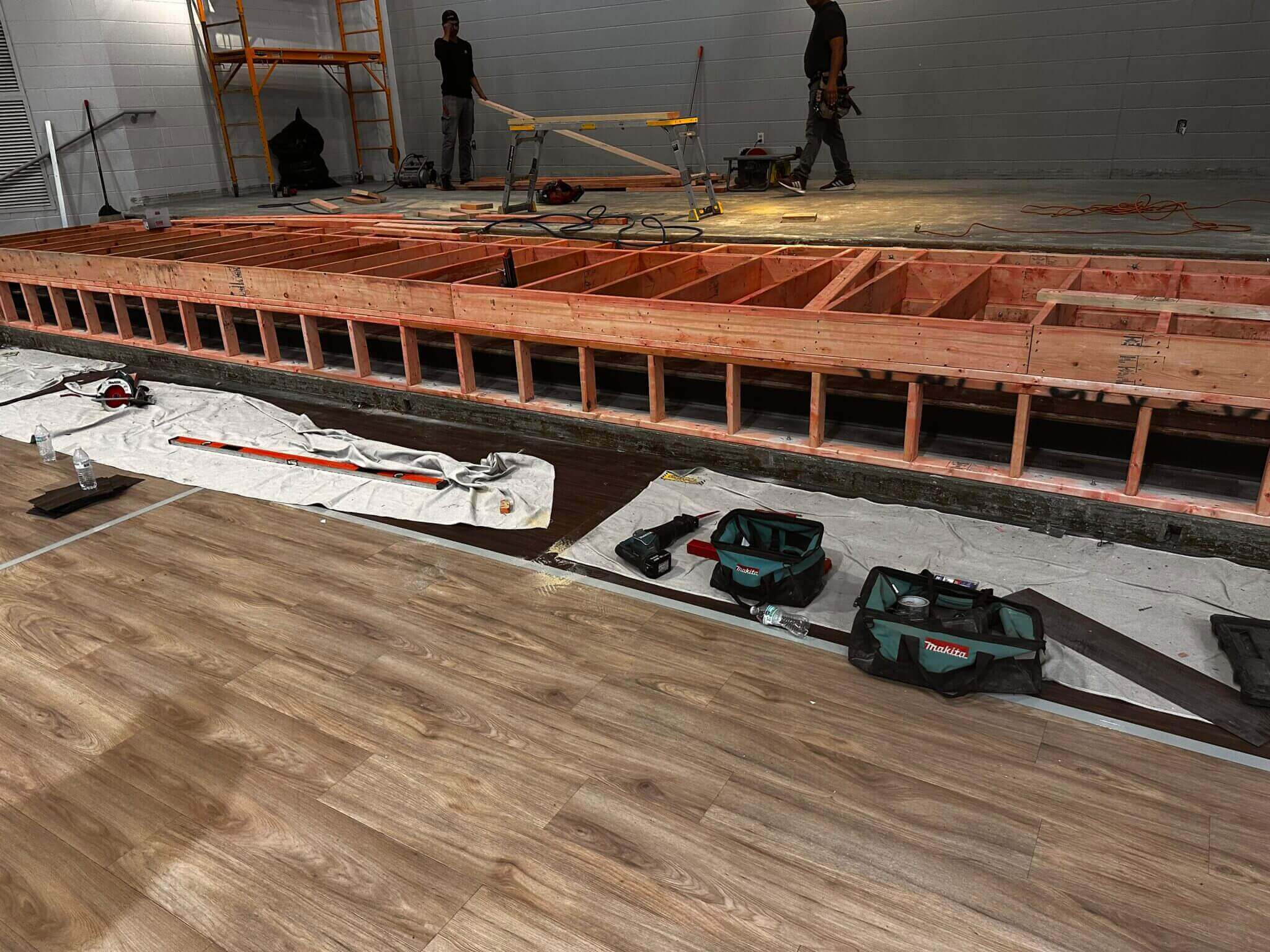 Construction site with wooden framework and tools.