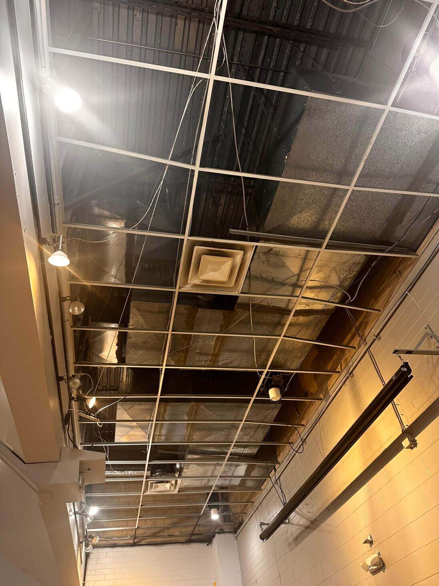 Exposed industrial ceiling with metal beams.