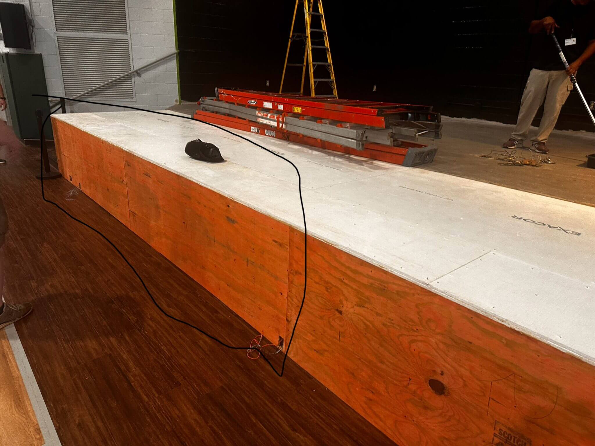 Stage construction with ladder and equipment.