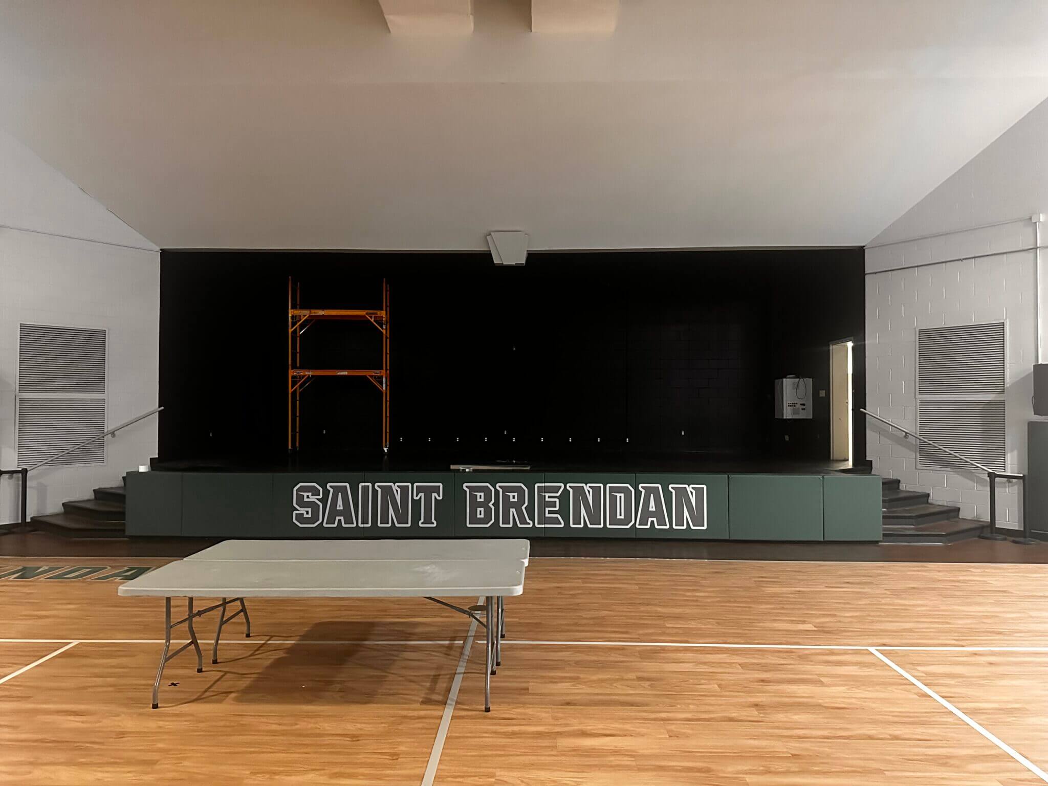 Stage and table in gymnasium.