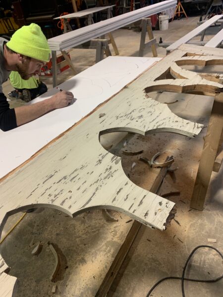 Man working on woodcut design project.